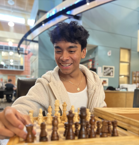  Anthony Herrera takes a break from class to play a quick game of chess. Students often find peace during their hectic day in the schools library.