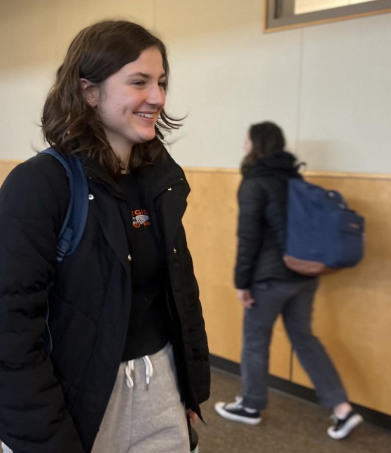 Senior Chloe Russel happily walks out of the building following the ringing of the final bell. Hundreds of students flood through the school before and after classes; following the start of the new semester, the halls feel quite a bit cheerier than before.