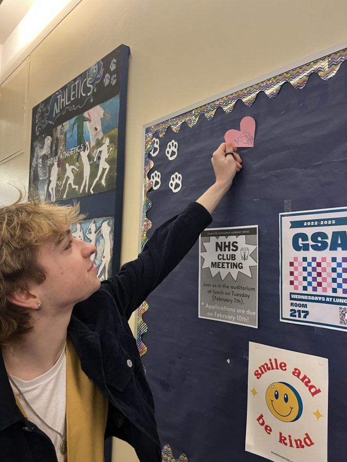 Senior, Elijah Sievers, taking down Valentine's day decorations. Hearts and kind notes filled the hallways at school.