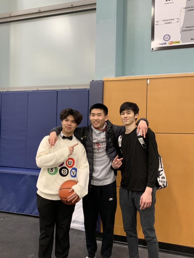 Seniors Maxim Wu and Nutipak Zirbes pose for a postgame picture. Both seniors were honored on Thursday for their hard work in their high school basketball careers.