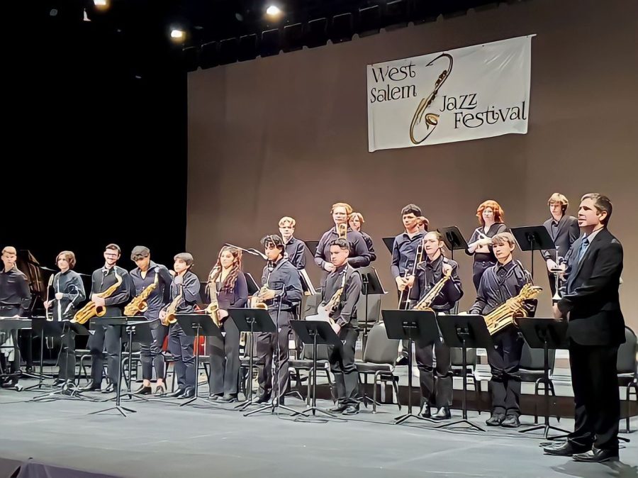 Mr. Davies stands like a king with the jazz band looking into the audience. They are performing at the West Salem Jazz Festival.