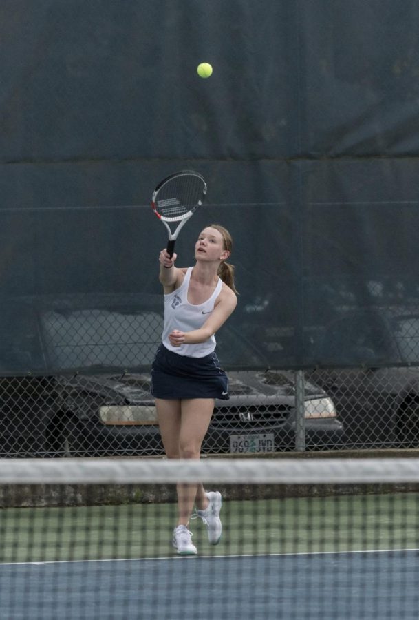 Class of 2022 senior Rachel Westing plays in a 2022 match. She is serving the ball into play. 