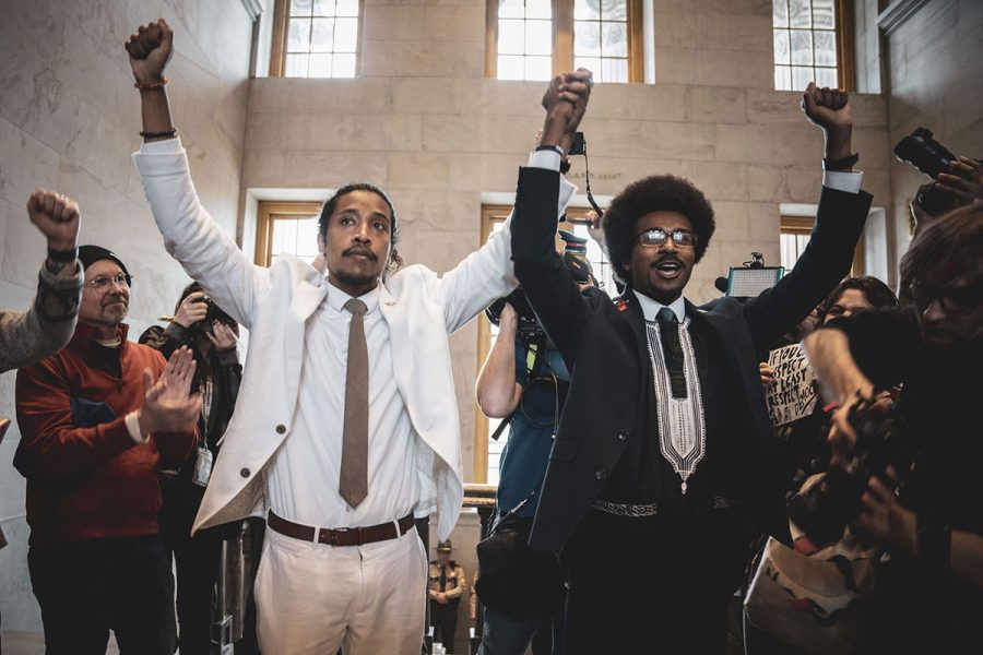 Jones (left) and Pearson (right) walk hand in hand in a moment of defiance ahead of a vote on their expulsions. 