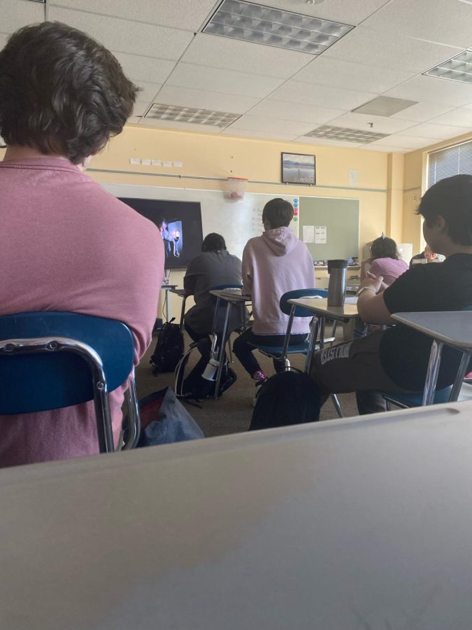 Student sitting in the front sits tall and listens to the lesson. His grade in the class is going to be an A. 