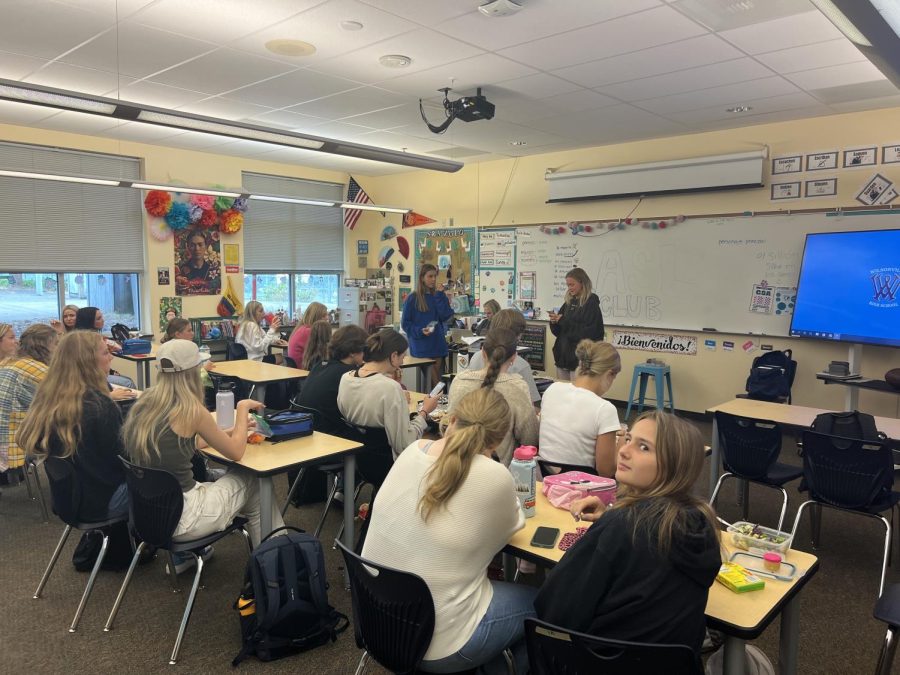 One of the first ASL club meetings during lunch. Everyone is sitting together while McIlmoil and De La Motte lead the group.