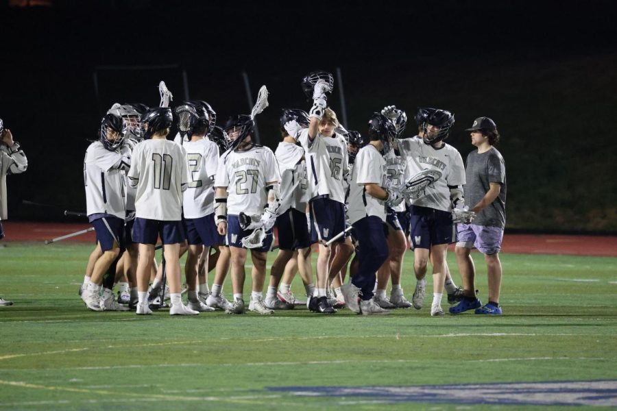 Wilsonville celebrates their win against Tualatin, meeting goalie Nathan Kim on the field