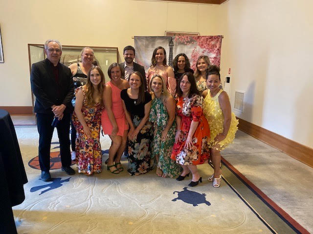 The chaperones pose for a picture in front of an Eiffel Tower background. We are so grateful for our staff spending their Saturday night at the Portland Zoo. 