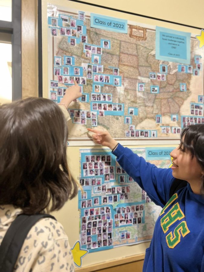 Seniors Jasmin Hernandez (right) and Emma Petersen (left) discuss their future plans in front of the College and Career Center. Here, students get to see where alumni have settled post-graduation in the previous year. 