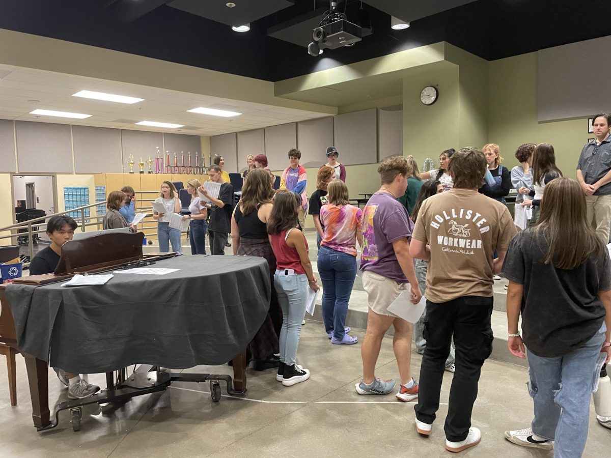 Students stand together at auditions for 'Elf.' The cast is excited to begin this adventure.