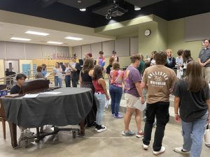 Students stand together at auditions for Elf. The cast is excited to begin this adventure.