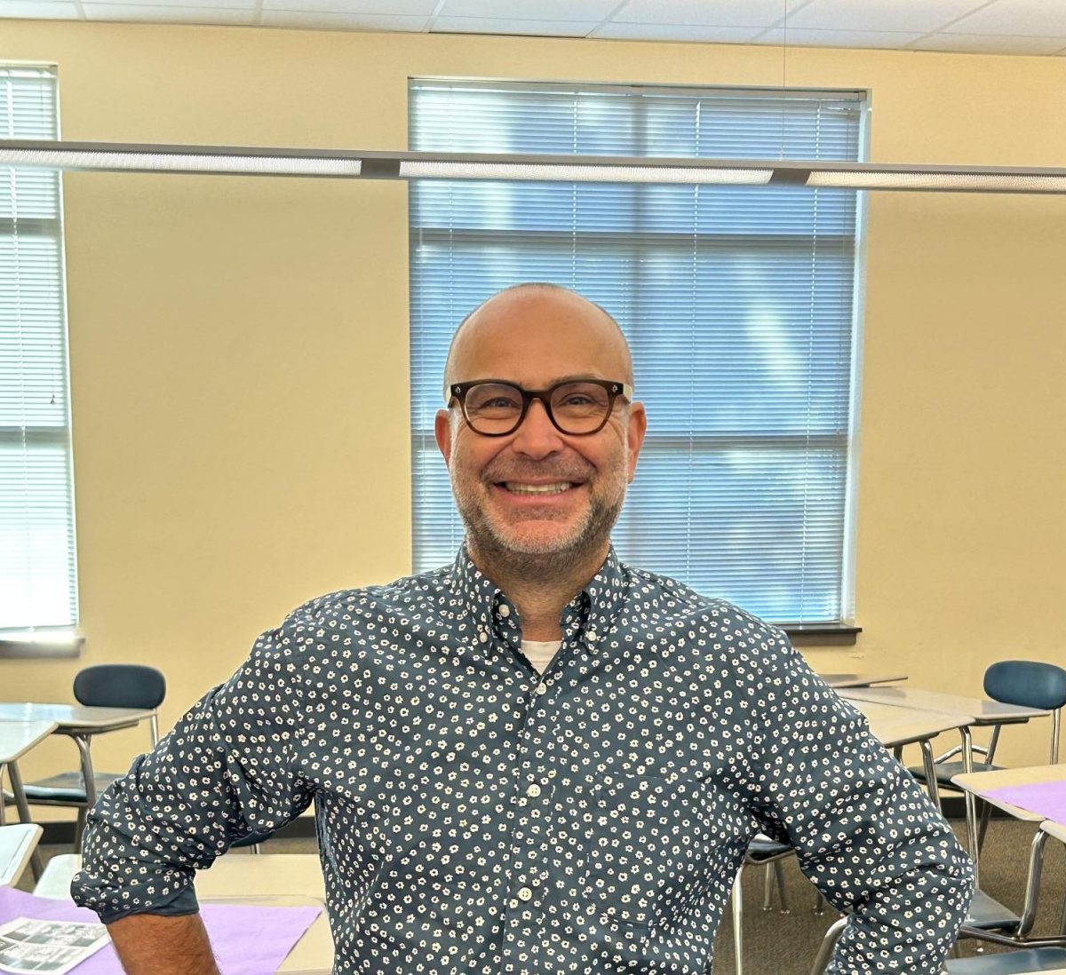 Mr. Gregor stands for his photo while he's setting up tables for his first period. 