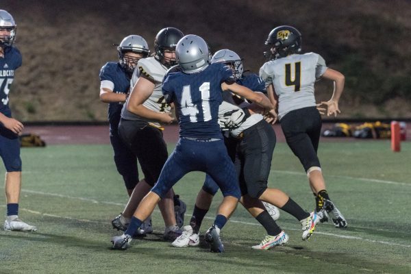 Sophomore Chandler Brock comes off the end for a sack.