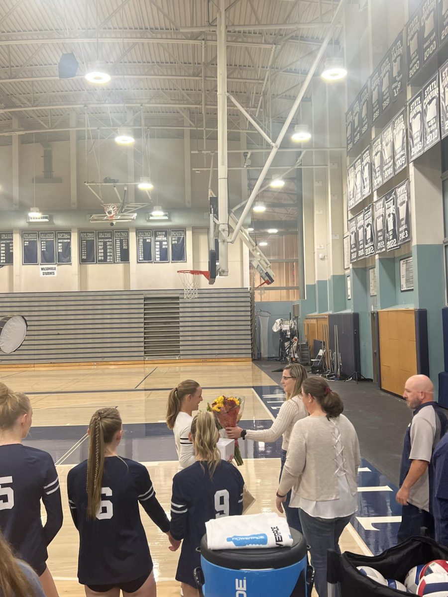 Mary Mathews the first senior presented during senior night, receiving her flowers from her family. They later took a picture together and congratulated the other seniors as they were called. 