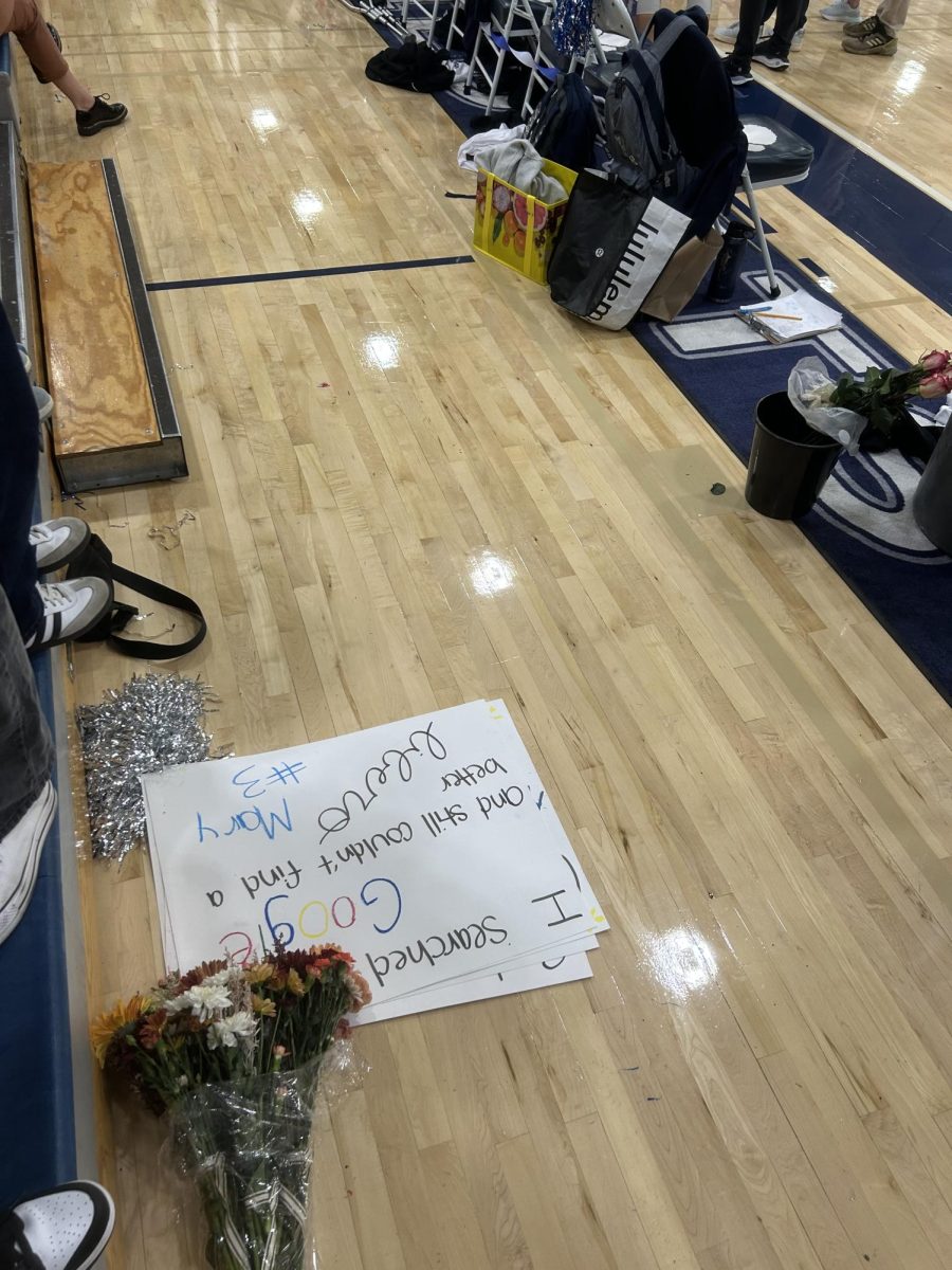 This picture captures the floor by the student section. The Wilsonville students showed their support for the seniors on the Volleyball team by making signs and giving flowers.