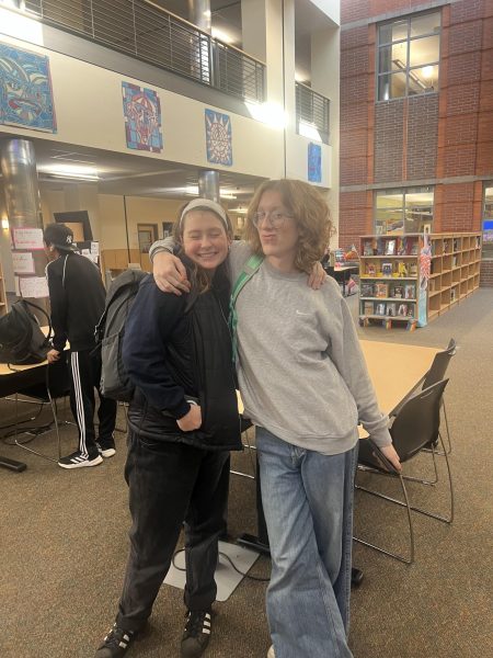 Seniors, Siona Ruud and Connor Nelson, pose during passing period to show off their outfits. They later headed to life class. 