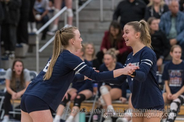 Seniors Ashlyn Hartford (left) and Cammy Gore (right) celebrate a point against Centennial on Senior night. The Wildcats would take down the Eagles in 3 sets.