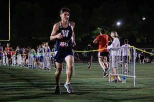 Wilsonville Cross Country team running in the night meet earlier in the fall. This was just the opener for a long and competitive XC season.
