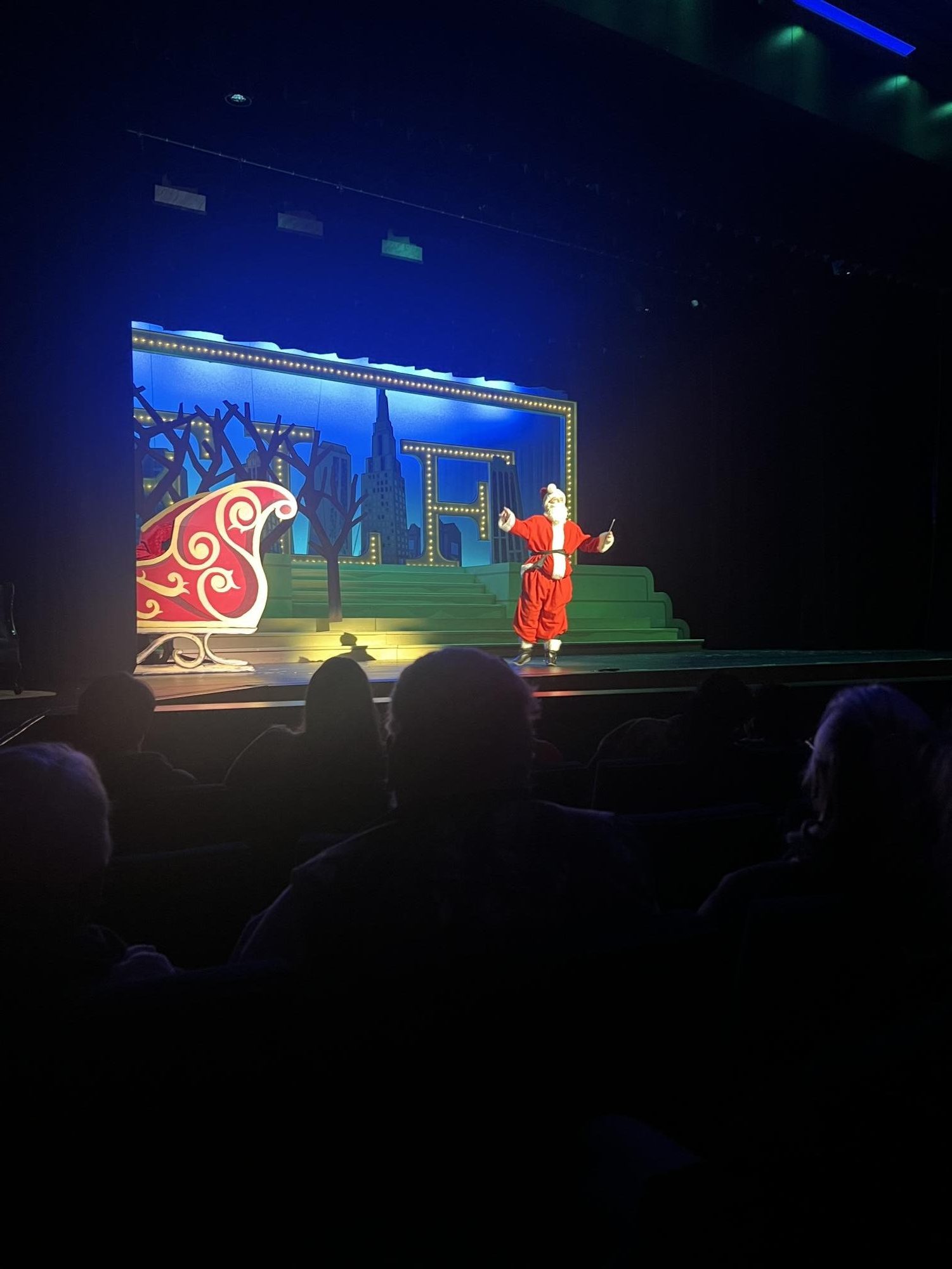 Santa, played by Sophia Caddell, provides a monologue for the audience. After this scene, Buddy's family performed a group scene. 