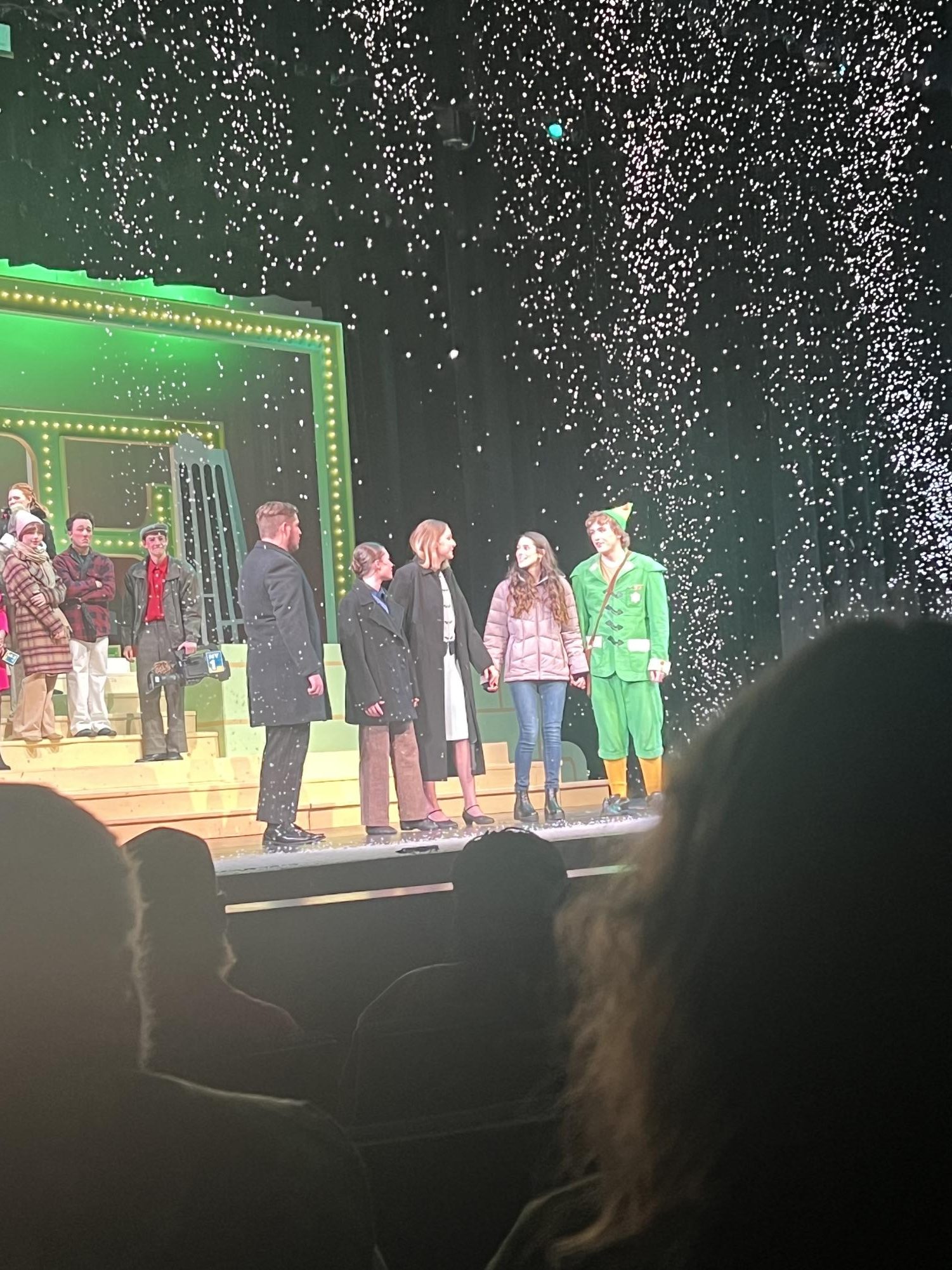 Jovie and Buddy's family join hand-in-hand under the snow. After, they sang a group Christmas carol. 