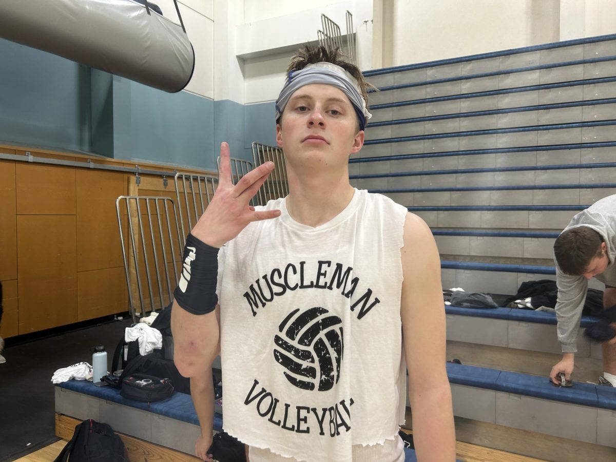 Senior Luke Larson after a victorious win against the juniors in Muscle Man. Reliving the glory of the 5A Football State Championship made this win in boys' volleyball even more exciting for the seniors.