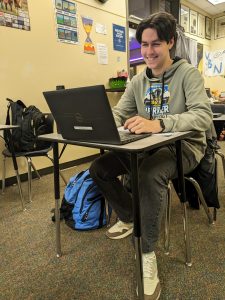 Senior Connor Larsen studying during class. He is hard at work, editing his article for WBN.
