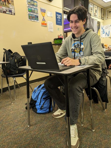 Senior Connor Larsen studying during class. He is hard at work, editing his article for WBN.