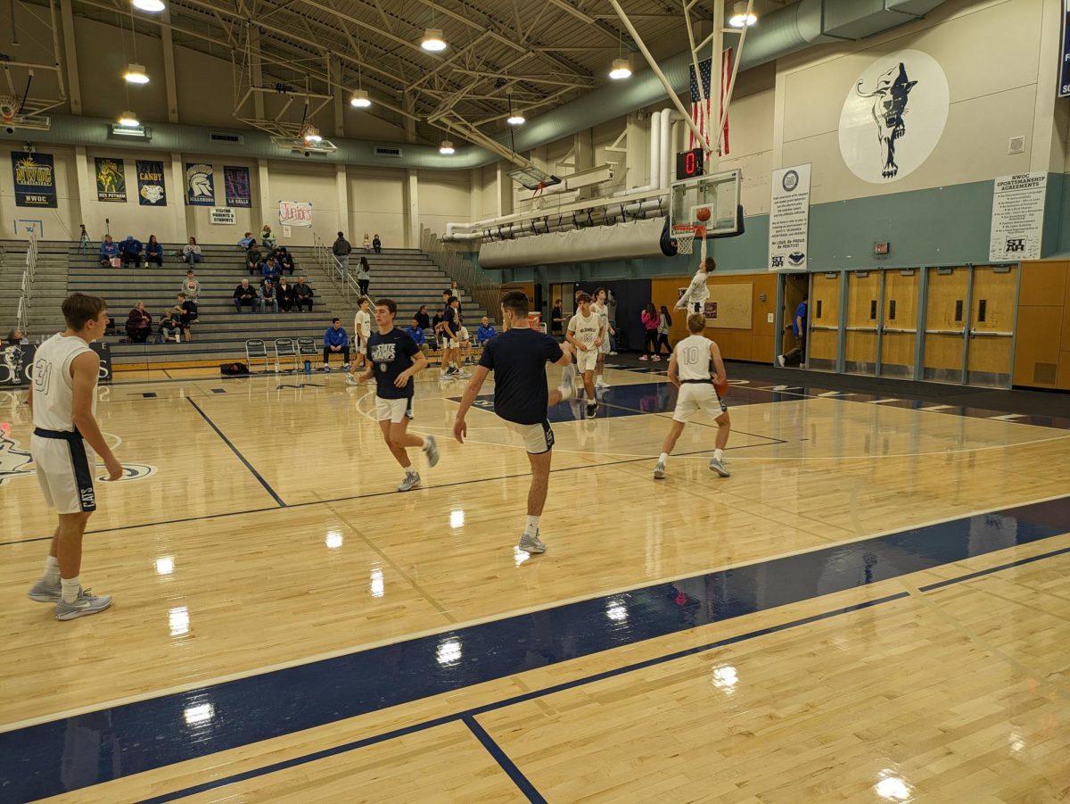 Wilsonville's Varsity boys warming up in the gym. Wilsonville entered the game as 3-0 facing Churchill, who was 2-1.