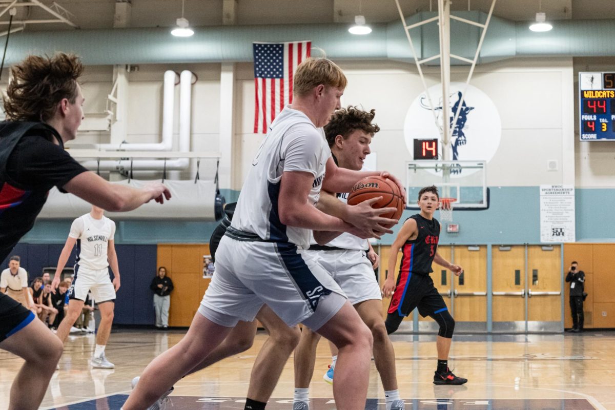 Junior C Emmitt Fee hustles for the rebound in the 4th quarter of a previous game. The second half of this game featured an admirable performance by Fee, who won the championship MVP in 2023. Photo provided by Greg Artman.