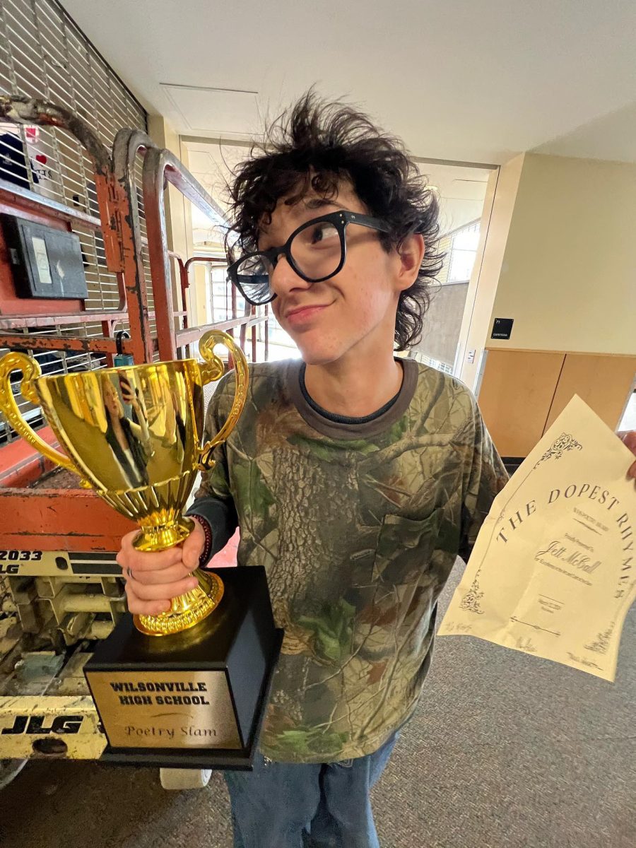 Jett McCall holding his award for his poem titled "Unnamed." He is planning on pursuing this art further in the future.