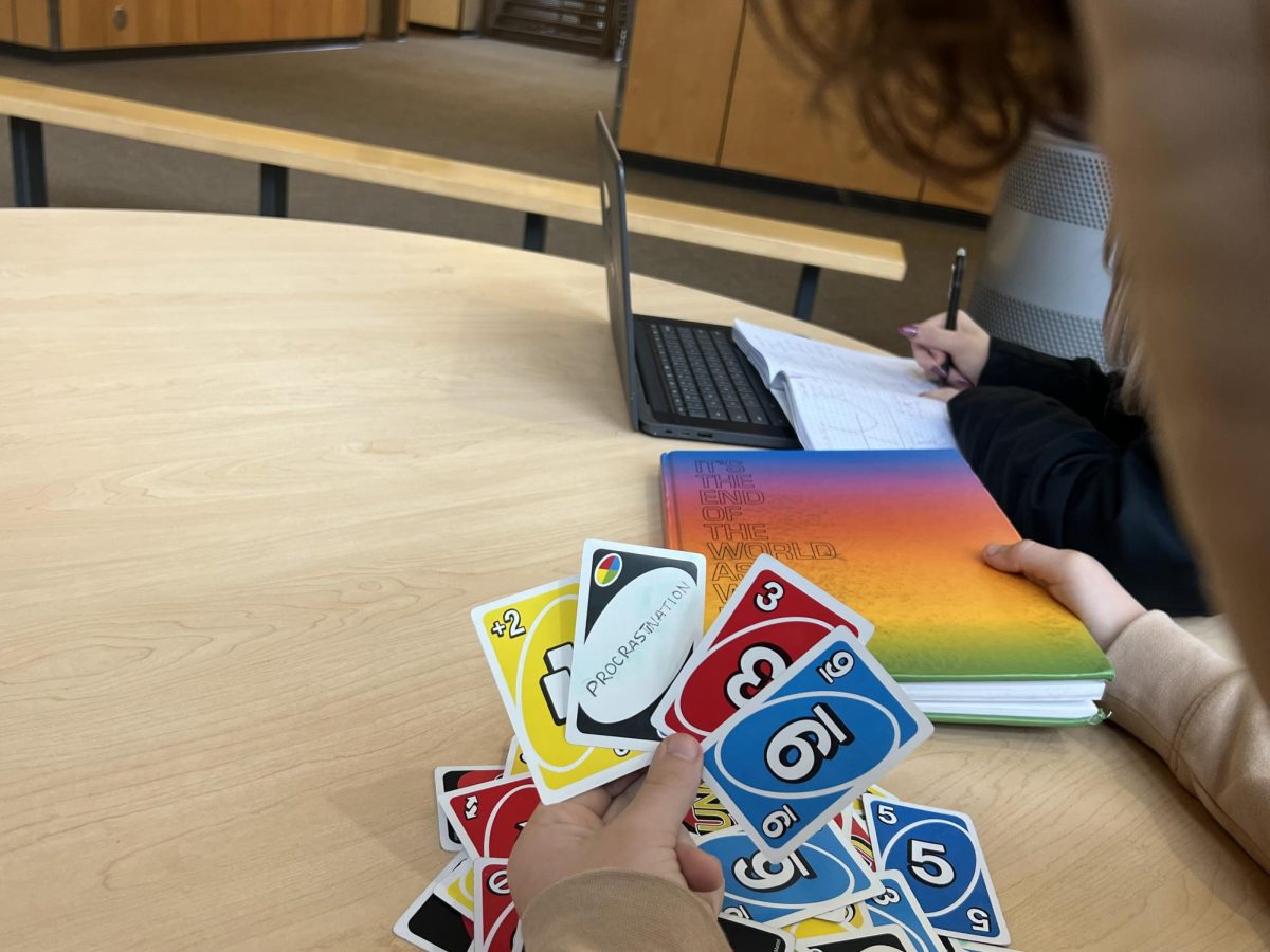 Senior Joel Thiessen chooses to play UNO instead of doing work with his partner. He procrastinates regularly. 