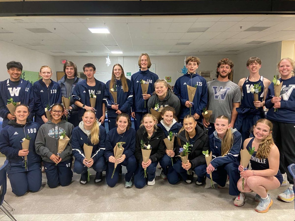 The seniors on the track team huddle together to pose on the first ever Wilsonville's track Senior Night. The ceremony was held in the cafeteria and the athletes enjoyed delicious food and cake after their last home meet of the season. Photo provided by Kiera Easterly.