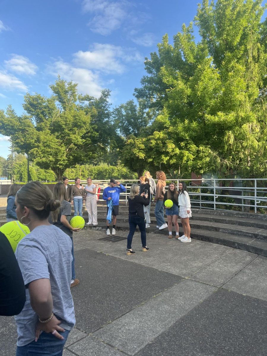 The Varsity players meet outside and take a couple pictures. They took a variety of photos on the stairs, while Seniors held their signed tennis balls from the team. 