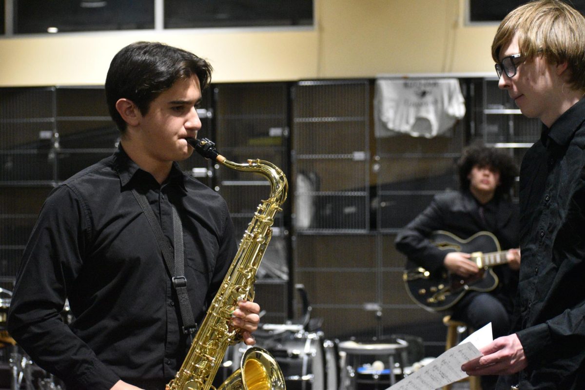 Ian Ellingson practices before the start of the concert. The band room fills with music as students flood in and have last-minute rehearsing. 