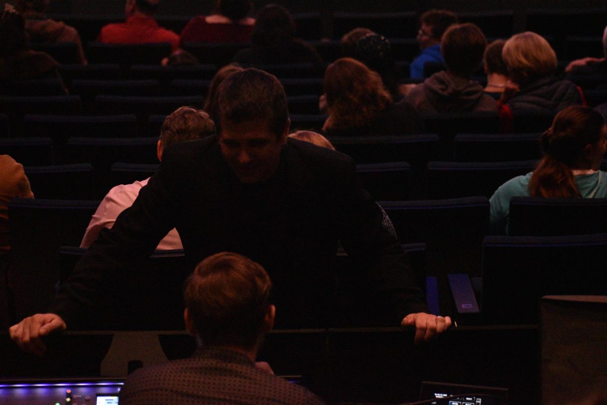 Band director Chad Davies discusses last minute technical concerns. Davies can be seen running around before almost every concert, trying to put together every piece of a concert puzzle. 