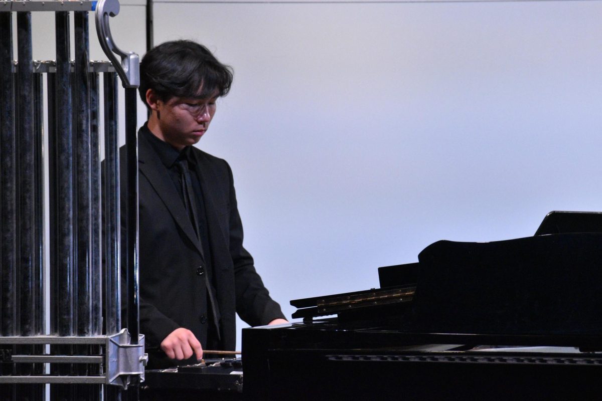 James Lee plays the xylophone, an addition to the percussion of the band. Later in the concert Lee shows his talents on the piano, an instrument that stay out of use in the moment. 