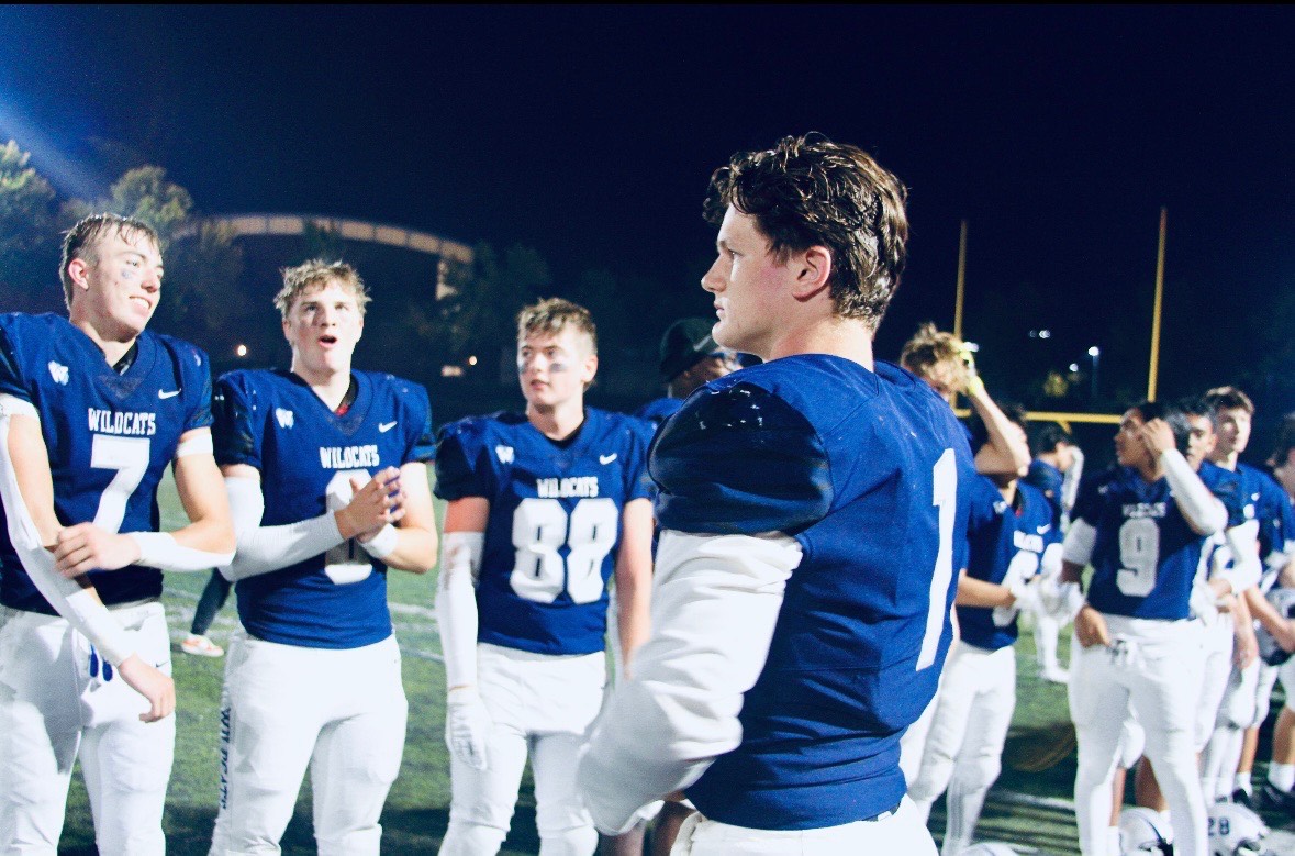 Senior quarterback Mark Wiepert leads the team in a post-game chant of Wilsonville's fight song. Whether win or lose, the Cats appear before their peers, parents, admin, and classmates to thank them and stand proudly in the humility of the team. 