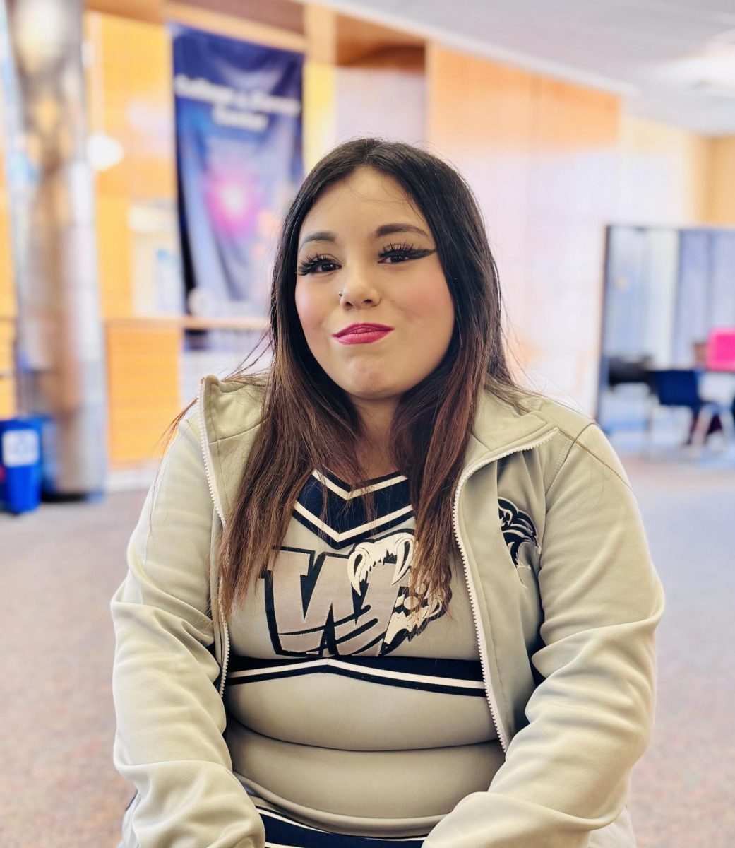 Wilsonville High School junior, Lizbeth Tapia Loeza poses outside of Mr. Coller's life class. Dressed down in the symbolic cheer uniform, Tapia Loeza represents the squad while she performs during the Homecoming assembly.