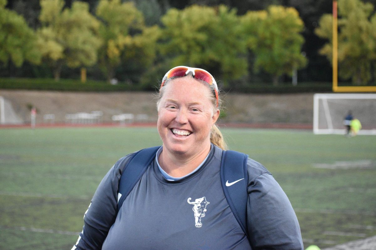 Tammy Sue Bradley smiling for a photo before coaching her JV soccer team to a victory. Tammy enjoys what she does and gives continuous support to students, athletes, and co-workers.