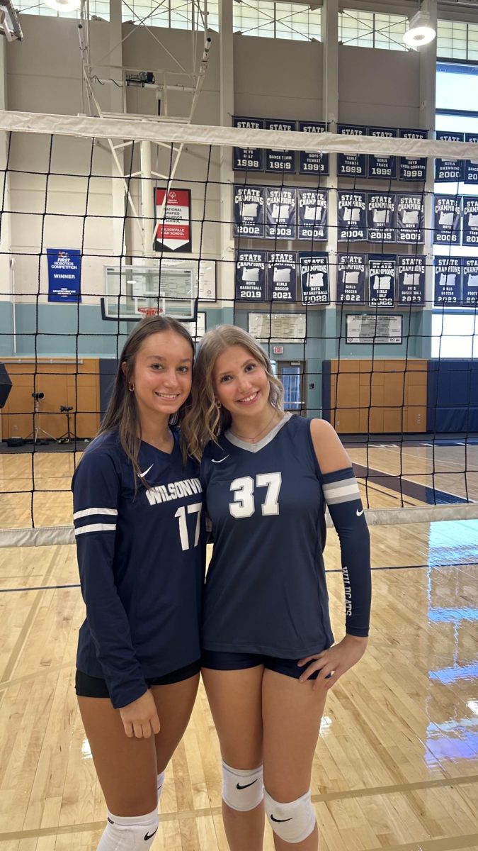 Alyssa Tornai poses with Ashley Patten for volleyball team photos. Tornai expresses her love and commitment to her sport. 