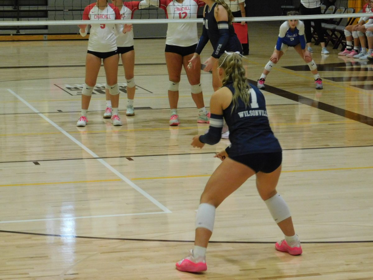 Defensive specialist Emily Holmes down and ready for the serve. The game begins.