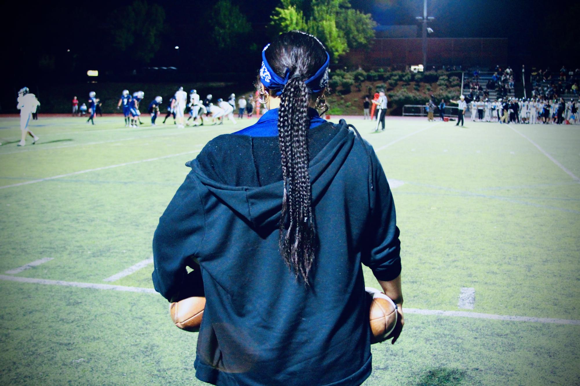 Varsity football team manager, Kehau, qualifies herself as "QB ball girl." She takes pride in her job assisting however she can, and being a waving example of the program's values and goals. 