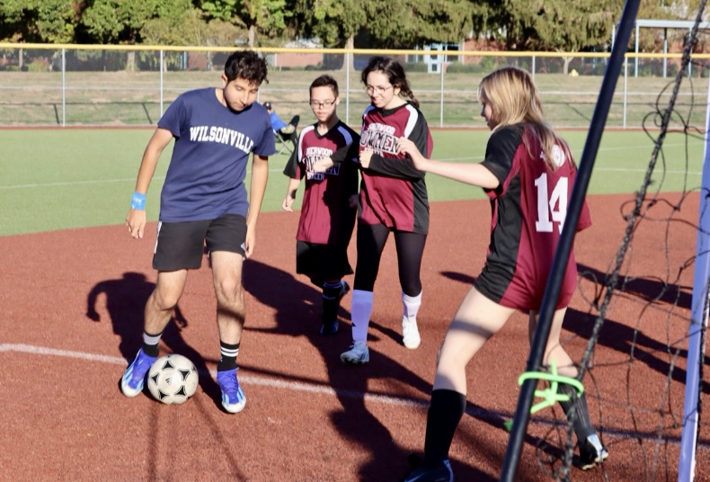 A Wildcat player attempts to take the ball past the Sherwood defenders, setting up one of their nine goals in the process. 