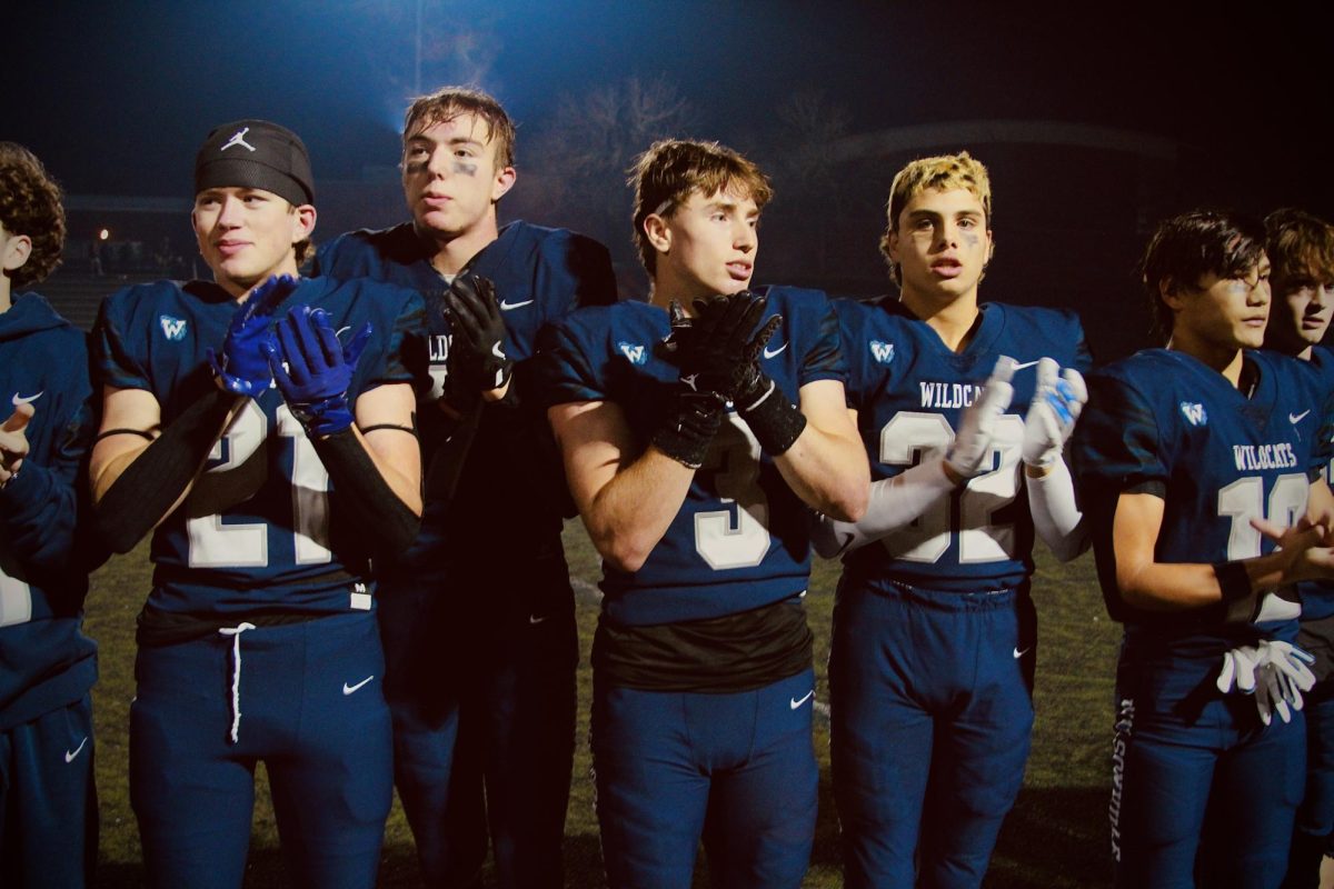 Riddick Molatore, Carter Christiansen, Nick Crowley, and the entire varsity football team sings the Wildcat song post-game. Win or lose, the Cats face their peers and parents with the song of spirit. 