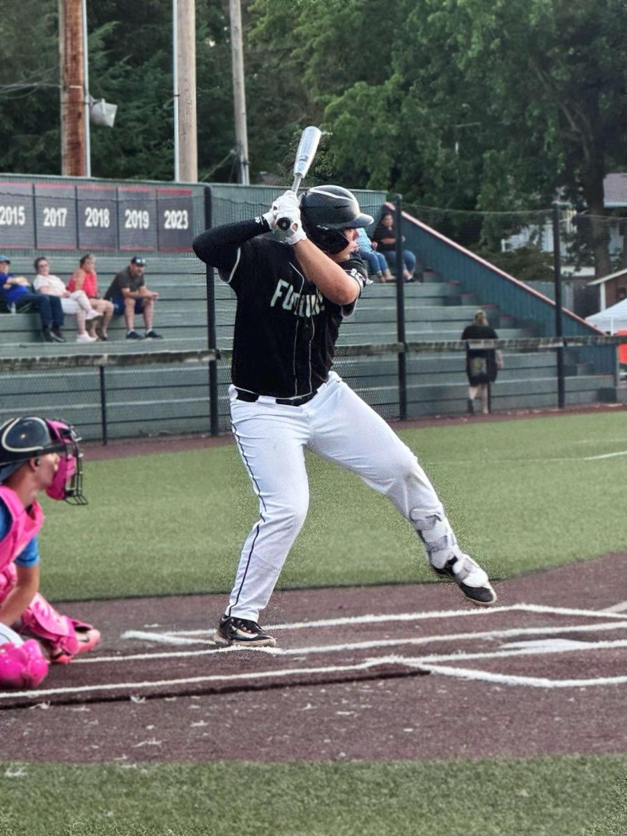 Junior Brody Cushing starts his load in preparation for the pitch. Cushing plays with the high school in the spring and then ventures up north to play with club team NW Futures in the summer.