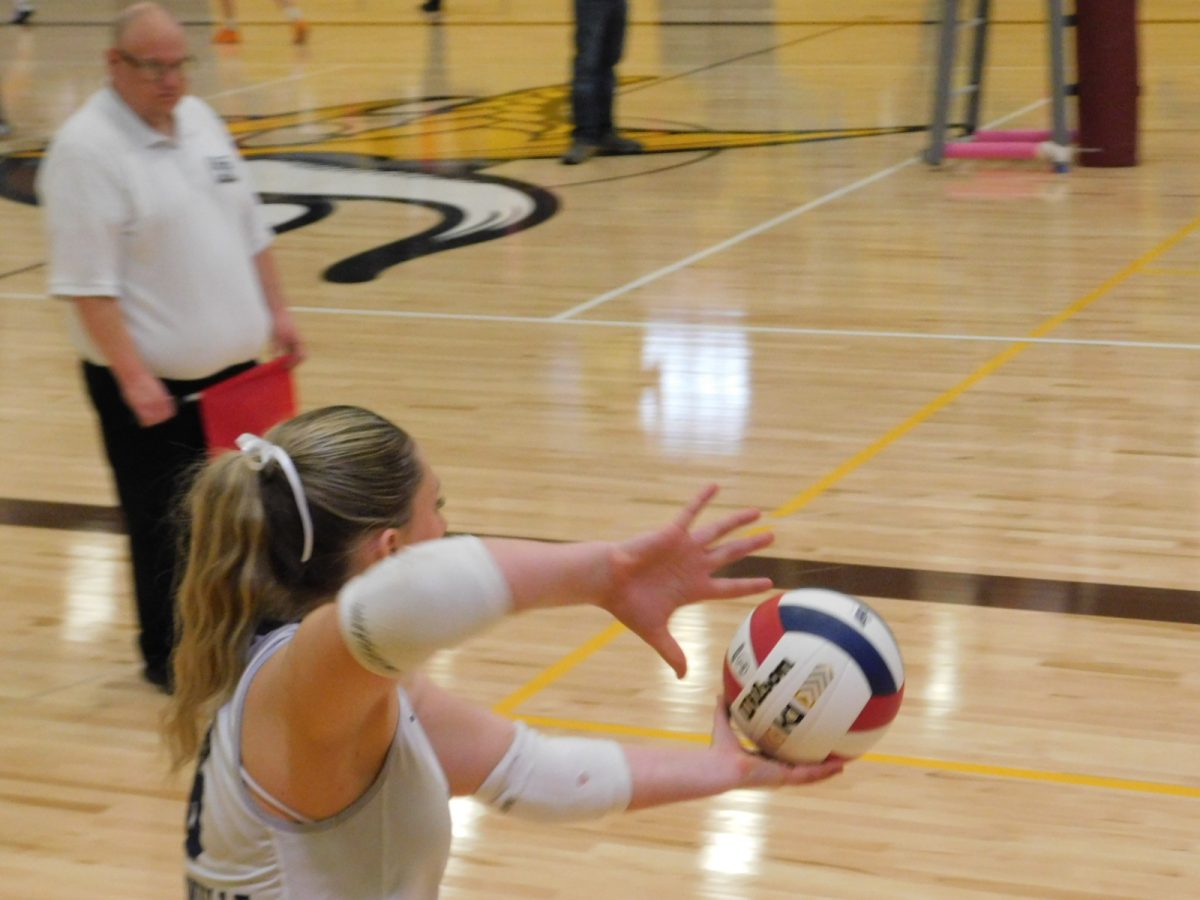 Our libero Olivia Clark up to serve after we win a point. She stays calm and sends Churchill a tough serve.