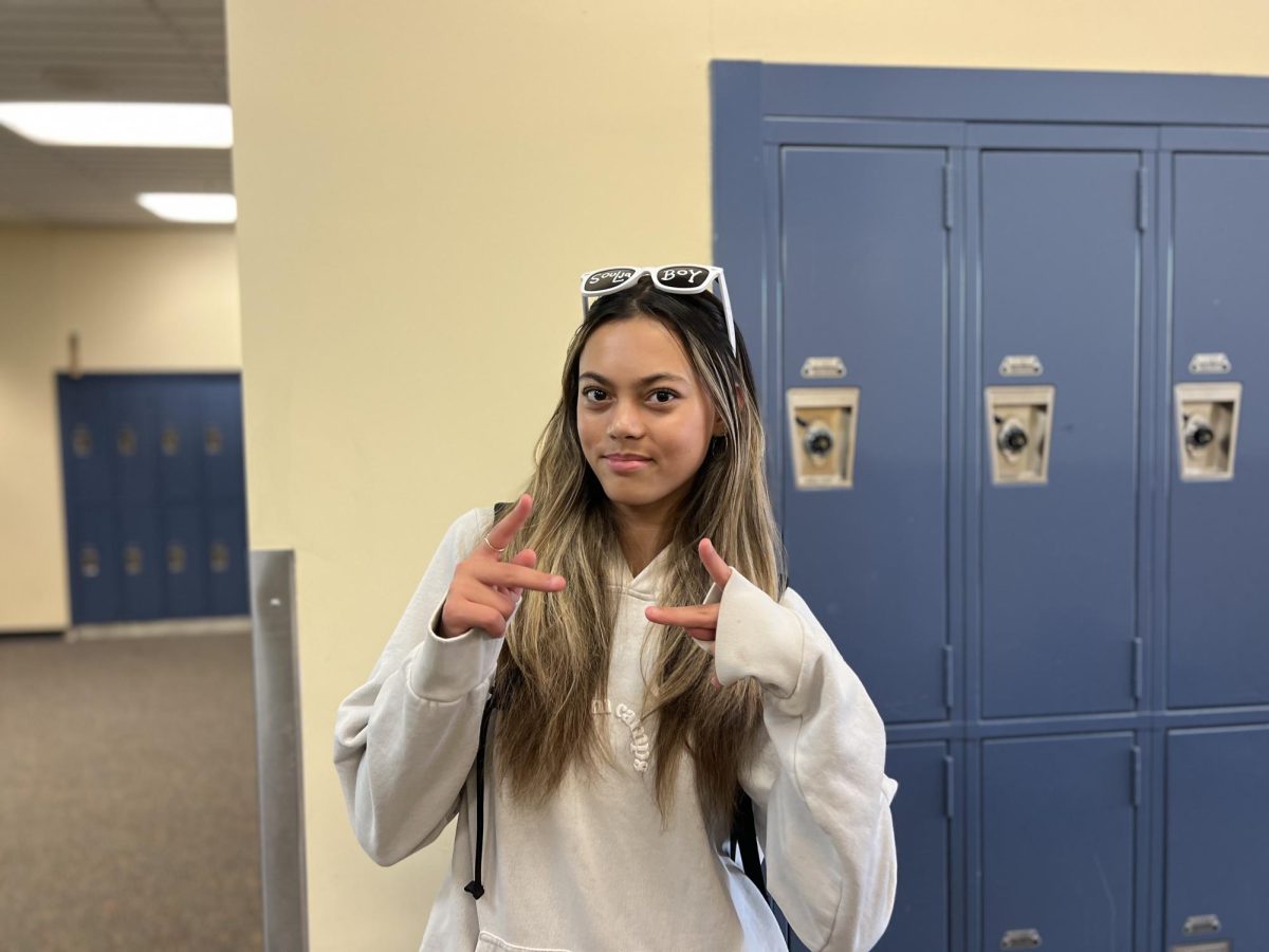 Olivia Abernathy walks the halls before class. The sophomore discusses the importance of cheer in her life. 