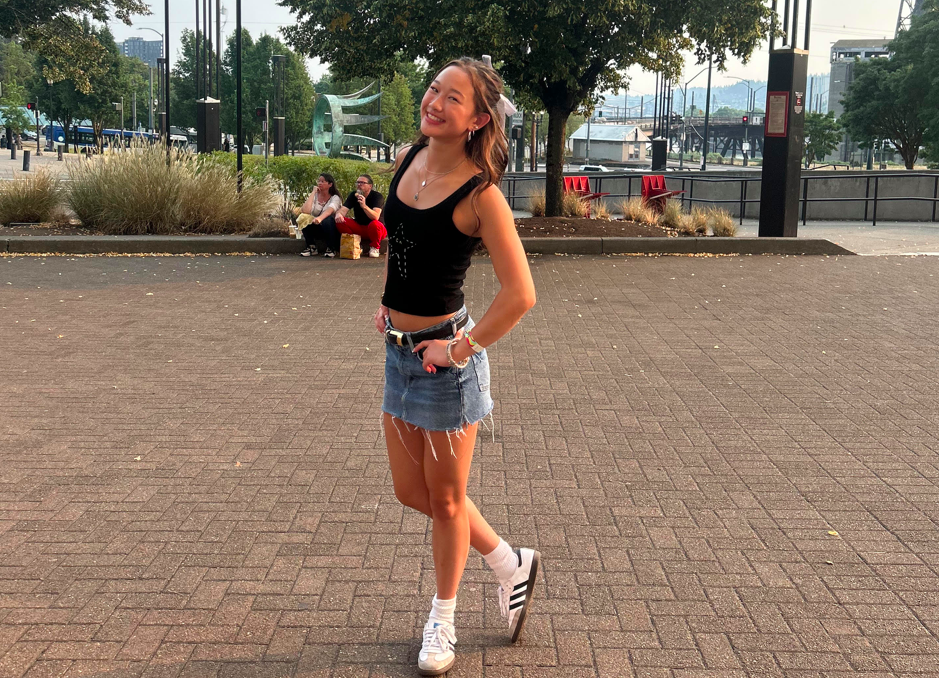 Junior Abby Khamvongsa was photographed in the urban streets. Framed by the essence of fall scenery, she smiles amid fresh air and in the company of family. Photo provided by Skye Forseth.