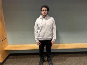 Adham Khashana poses for a picture in the school entryway. Khashana has lived across the world and after several moves has found a home in Wilsonville.