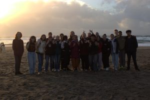 Group photo taken on the beach of choir, band, and orchestra students where they did bonding games and activities. 