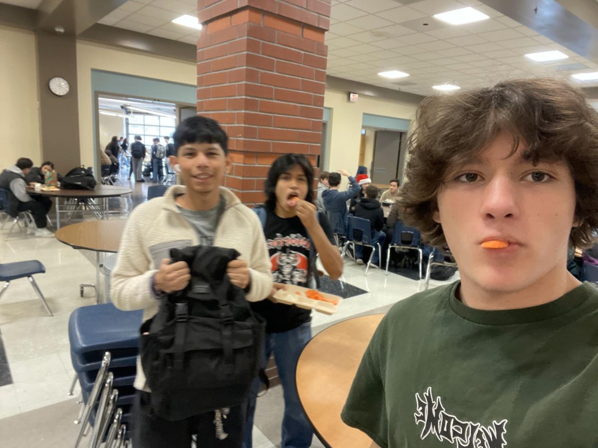 Isaiah Kessler is enjoying carrots with his friends during lunch.  After school he will go to work.                                